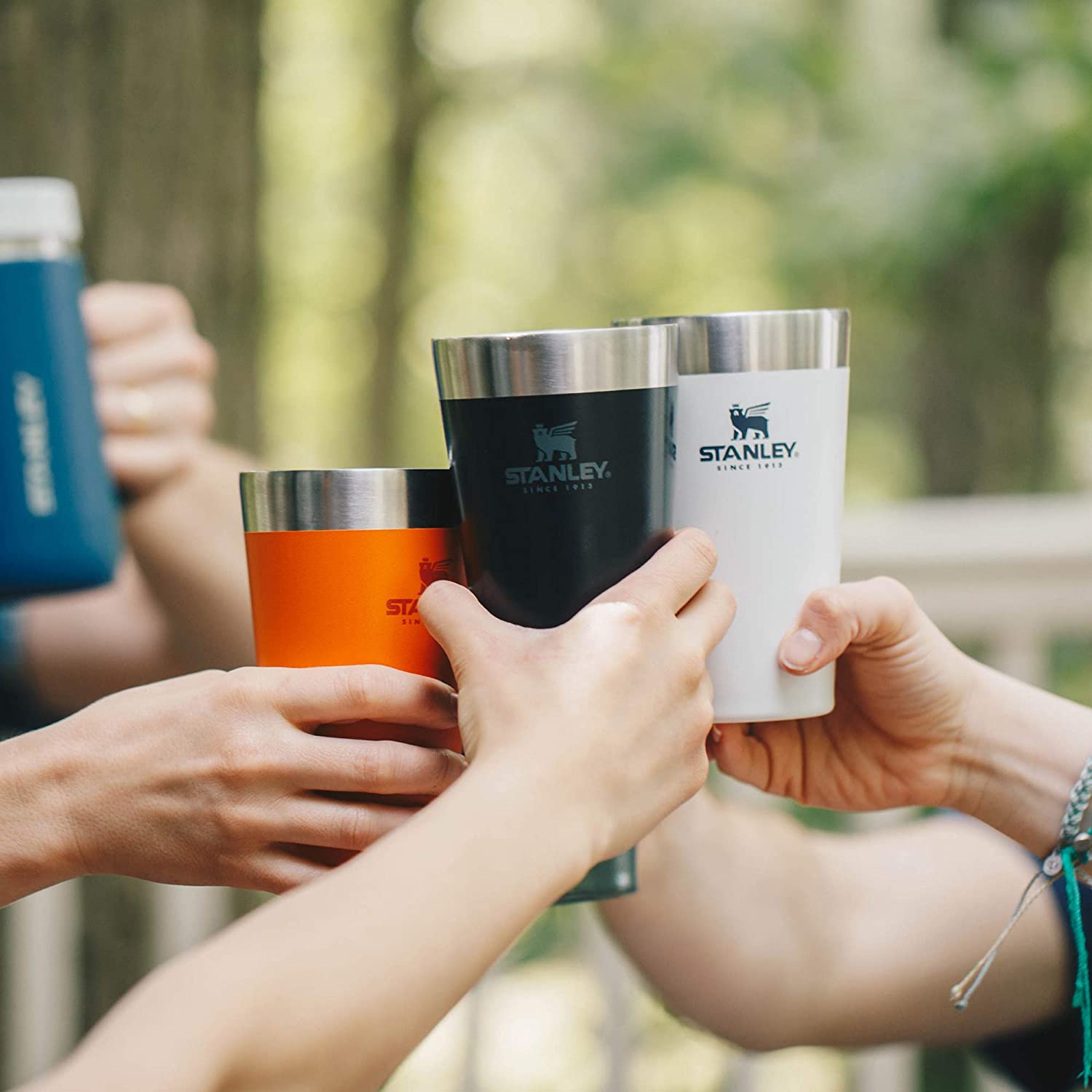 4 People cheering with stanley stacking beer pints.