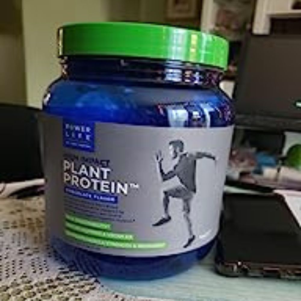 Jar of Power Life high impact plant protein, chocolate flavor, sitting on a kitchen counter.