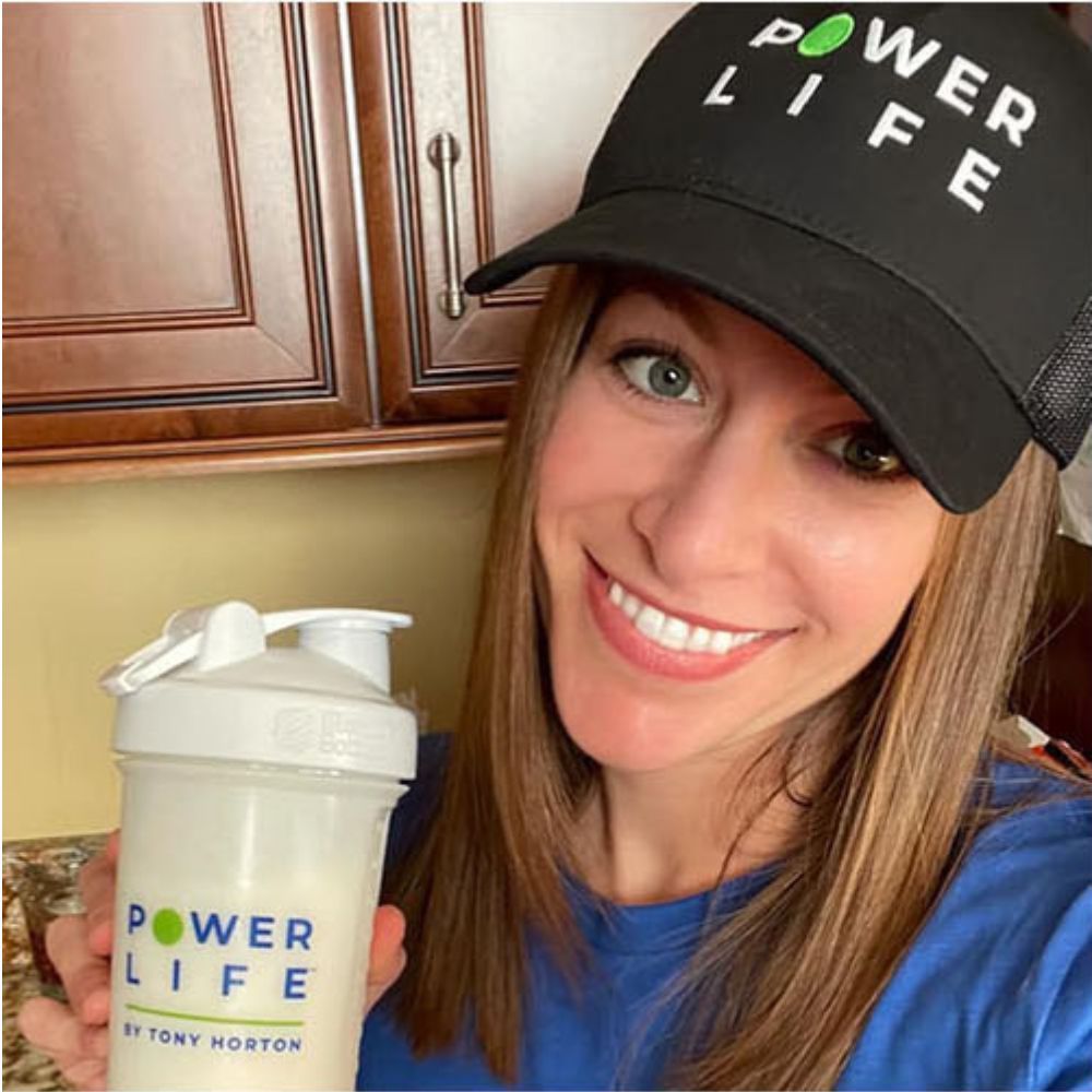 Women with Power Life ball cap on holding a power life shaker bottle.